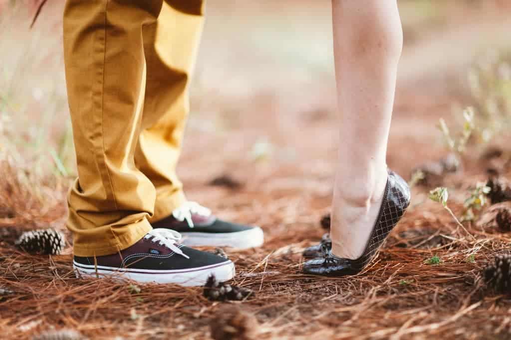 Closeup of woman standing on tiptoe with man min