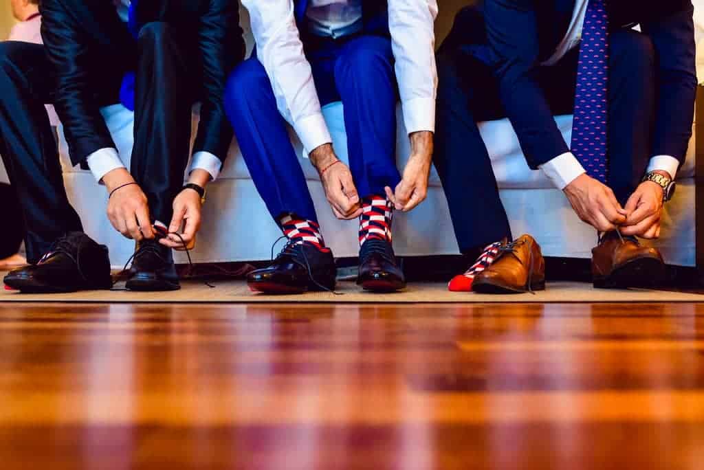 Men Tying their Leather Shoes min