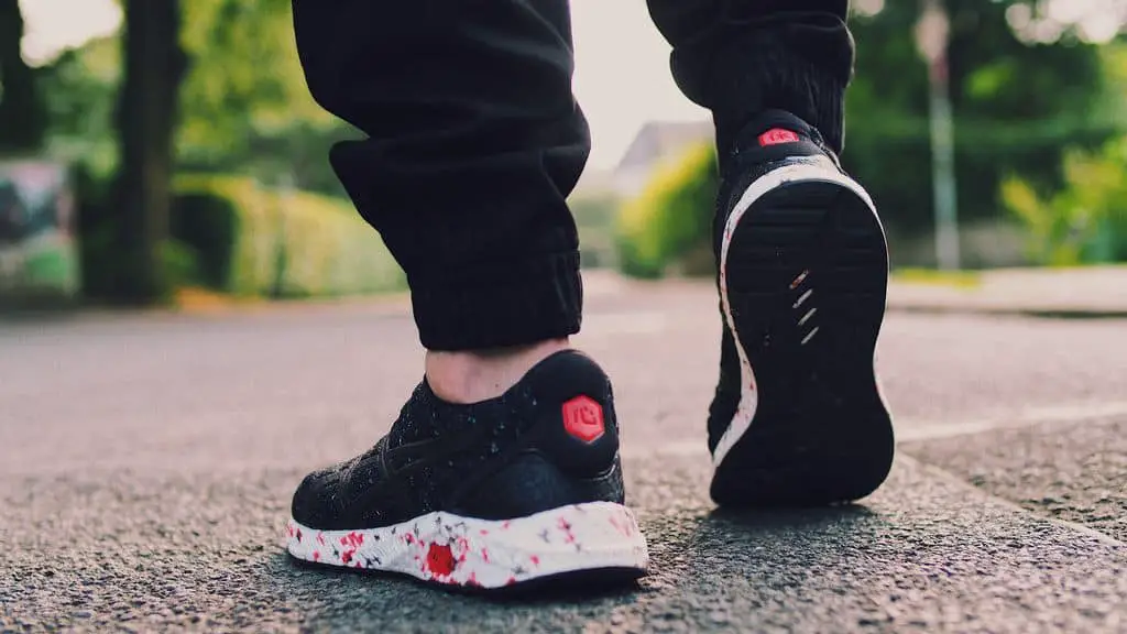 Person in Black Sneakers Walking on Street (1)